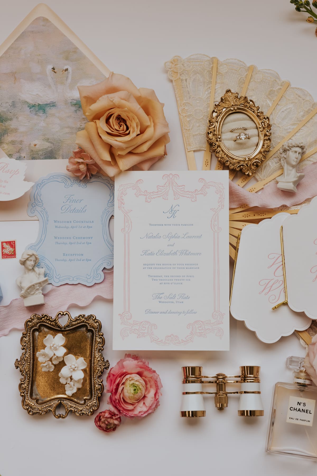 A wedding invitation suite with flowers and heirloom details